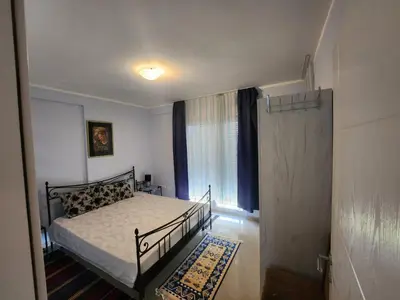 a small bedroom with a bed and a window at Apartman Goca in Vrnjačka Banja
