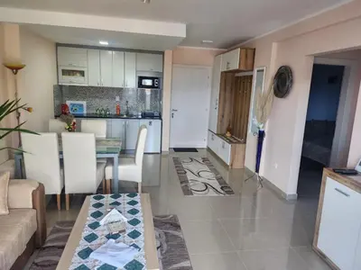 a living room and kitchen with a table and chairs at Apartman Goca in Vrnjačka Banja