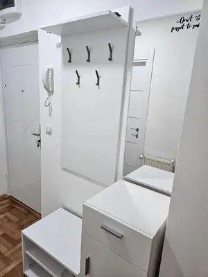 a white bathroom with a mirror and a phone at ONLY 4 YOU apartment in Niš