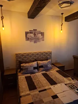 a bedroom with a bed in a room with lights at ThEOS in Vranje