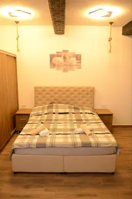 a bedroom with a bed with two towels on it at ThEOS in Vranje