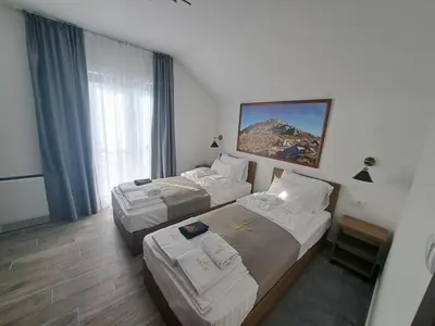 a hotel room with two beds and a window at Soko IN Spa in Soko Banja