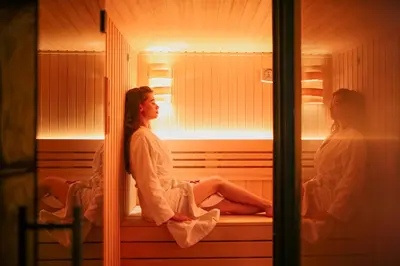 two women sitting in a sauna looking out a window at Soko IN Spa in Soko Banja