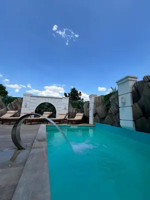 a swimming pool with a water slide at Soko IN Spa in Soko Banja