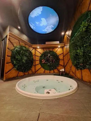 a jacuzzi tub in a room with plants at Soko IN Spa in Soko Banja