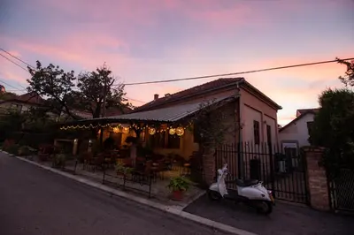 a scooter parked in front of a house at Pansion Nana in Aleksandrovac