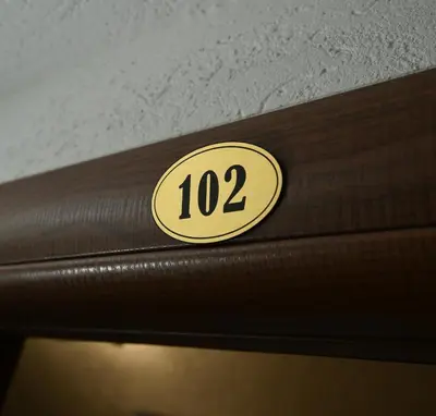 a number on the side of a wooden door at Pansion Nana in Aleksandrovac