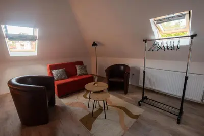 a living room with a red couch and chairs at Pansion Nana in Aleksandrovac