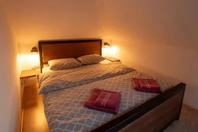 a bedroom with a bed with two pillows on it at Pansion Nana in Aleksandrovac