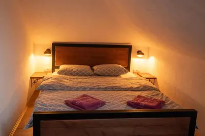 a bedroom with a bed with two towels on it at Pansion Nana in Aleksandrovac
