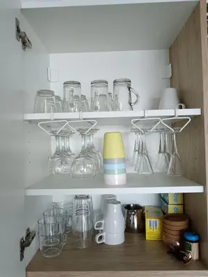 a cupboard filled with lots of glasses and other items at Apartman TRAMONTO Kopaonik in Kopaonik