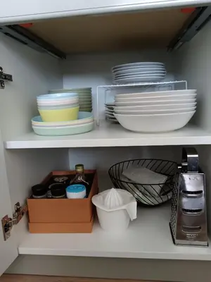 a cupboard with plates and bowls and other dishes at Apartman TRAMONTO Kopaonik in Kopaonik