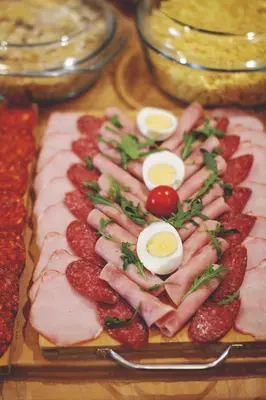 a tray of food with meat and eggs on it at B&B Vila Tamaris in Zaječar