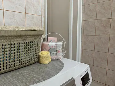 a white microwave sitting on top of a counter in a bathroom at Apartman NANA in Ćuprija