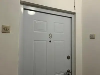 a white garage door in a room with two switches at Apartman NANA in Ćuprija