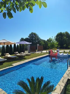 a swimming pool with a boat in a yard at Slatinska idila - kuća sa bazenom in Bunar