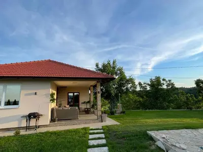 a house with a patio and a grass yard at Slatinska idila - kuća sa bazenom in Bunar