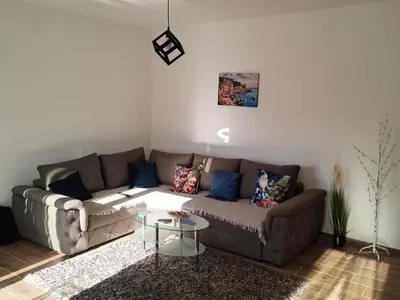 a living room with a couch and a table at NinaRelax in Soko Banja