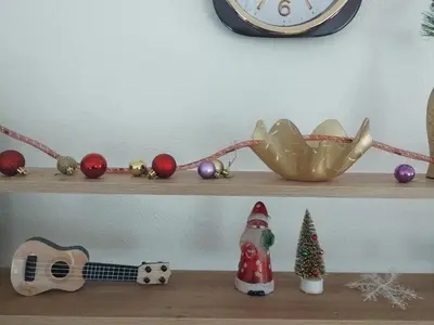 a shelf with christmas decorations on it with a clock at NinaRelax in Soko Banja