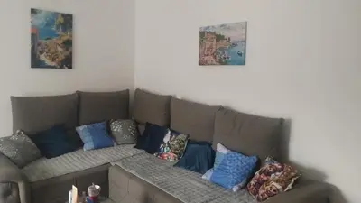 a couch with pillows on it in a living room at NinaRelax in Soko Banja