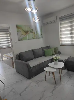 a living room with a couch and a table at SokoSTAR Apartman in Soko Banja