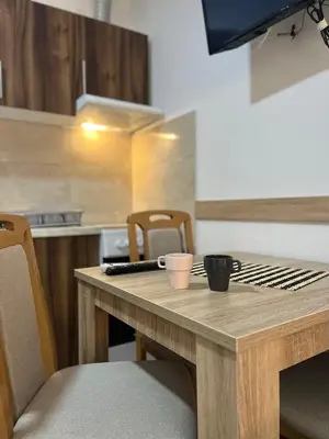 a wooden table with two cups on it in a kitchen at Apartman Nestoria Sokobanja in Soko Banja