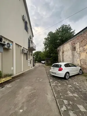 a white car parked on the side of a street at Apartman Nestoria Sokobanja in Soko Banja