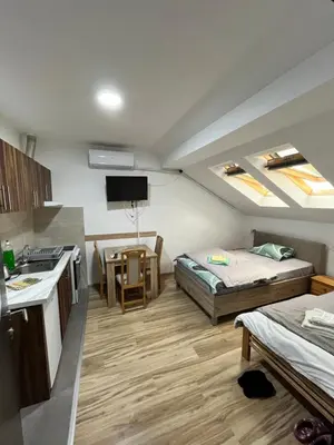 a small room with two beds and a kitchen at Apartman Nestoria Sokobanja in Soko Banja
