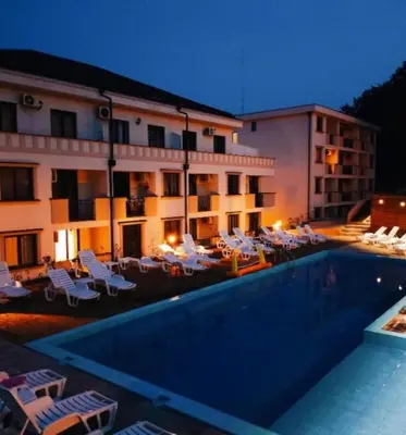 a hotel with a swimming pool in front of a building at Vrnjački Kos in Vrnjačka Banja