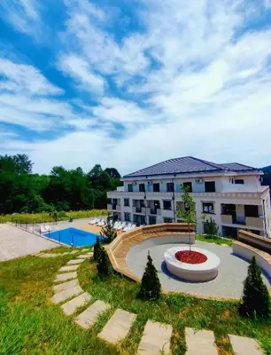 a large apartment building with a pool in front of it at Vrnjački Kos in Vrnjačka Banja