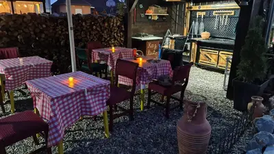 a restaurant with tables with lit candles on them at Odmaraliste Kod Mice Apartman 5 in Krušar