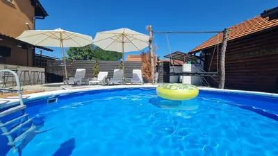a swimming pool with a ball in the water at Odmaraliste Kod Mice Apartman 5 in Krušar