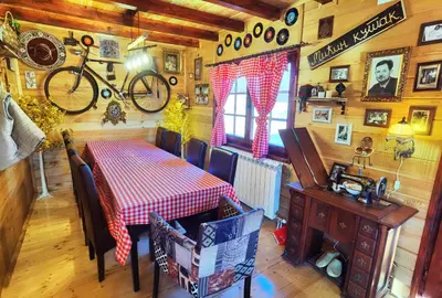 a dining room with a table and a bike on the wall at Odmaraliste Kod Mice Apartman 5 in Krušar