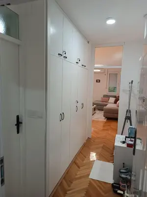 a room with white walls and a sliding door at ZONA apartman in Vranje