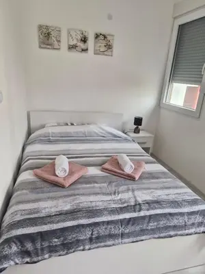 a bedroom with a bed with two towels on it at ZONA apartman in Vranje