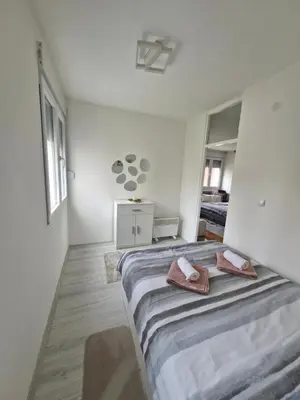 a bedroom with a bed with two towels on it at ZONA apartman in Vranje