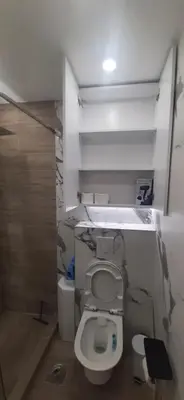 a bathroom with a white toilet in a room at ZONA apartman in Vranje