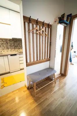 a kitchen with a bench in the middle of a room at Apartment sPARK Niš in Niš
