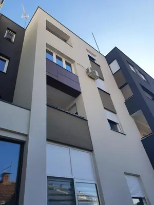 a tall building with a lot of windows at Apartment sPARK Niš in Niš