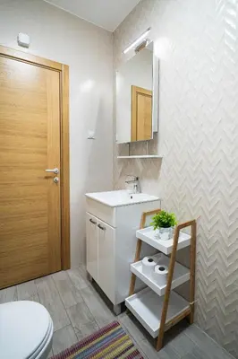 a bathroom with a sink and a toilet and a mirror at Apartment sPARK Niš in Niš