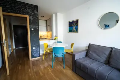 a living room with a couch and a table at Apartment sPARK Niš in Niš