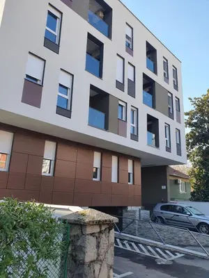a building with a car parked in front of it at Apartment sPARK Niš in Niš