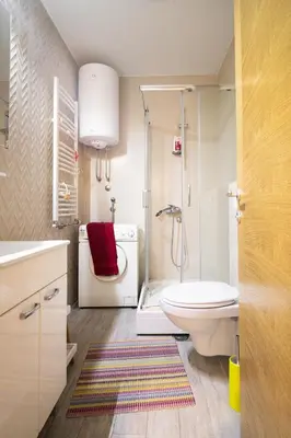 a bathroom with a shower and a toilet and a sink at Apartment sPARK Niš in Niš