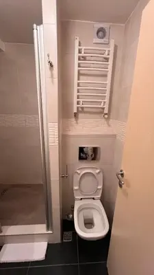 a small bathroom with a toilet and a shower at Ski centar konaci Kopaonik in Kopaonik