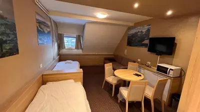 a small room with a bed and a table at Ski centar konaci Kopaonik in Kopaonik