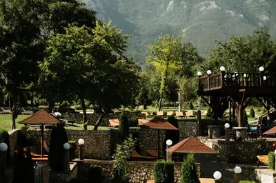a view of a park with a bridge and trees at Etno hotel Balasevic Rtanj in Boljevac