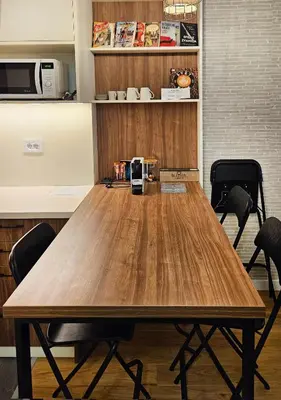 a large wooden table in a room with chairs at Cozy Mountain Apartment VIDIK in Kopaonik