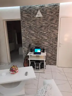 a living room with a laptop on a table at Center Apartment in Niš