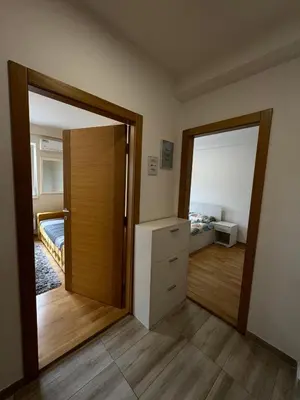 a room with a door and a bedroom with a bed at Olimp apartmani Sokobanja in Soko Banja