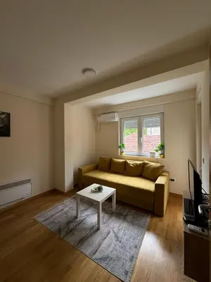 a living room with a couch and a coffee table at Olimp apartmani Sokobanja in Soko Banja